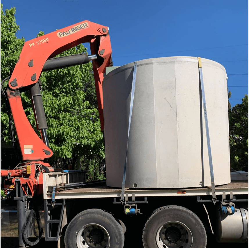 Aerated Wastewater Treatment System Tank arriving on truck with a crane