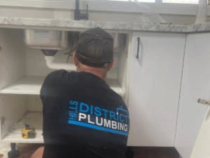 Plumber fixing leaking pipe