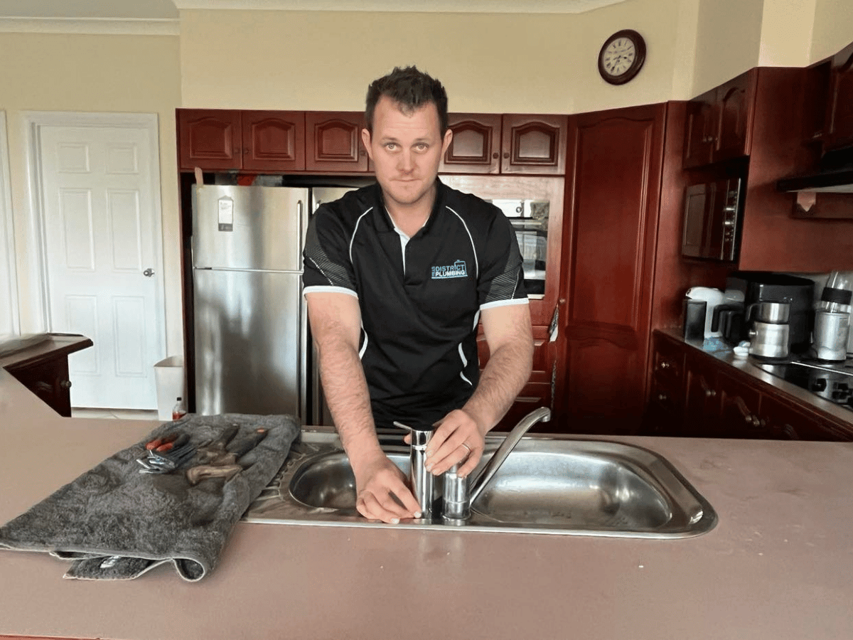 Plumber replacing tap